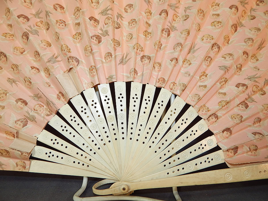Victorian Baby Cherubs Angel Doves Print Pink Paper Pleated Large Folding Fan
This large fabulous folding fan has carved and pierced bone sticks and guards, a celluloid ring, rivet holding the fan together at the bottom and is backed in a pastel pink fabric. 