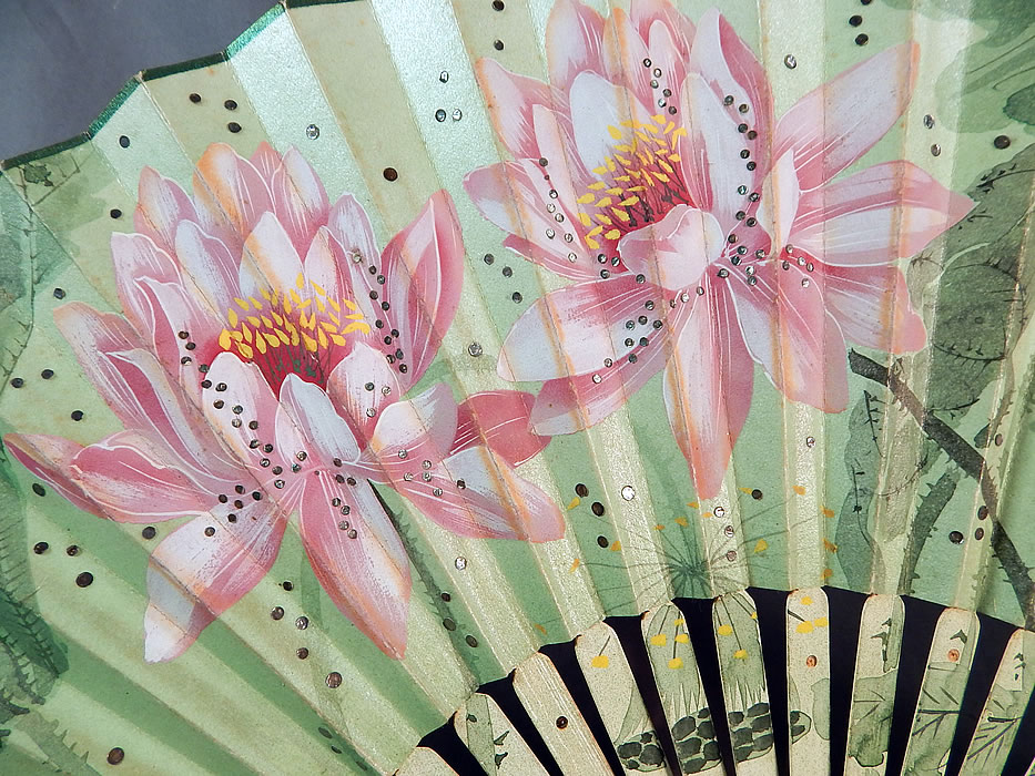 Art Nouveau Asian Hand Painted Paper Lotus Flower Sequin Pleated Folding Fan
It is made of a pleated opalescent white paper, with hand painted pink lotus flowers and celadon green thorny stems, leaves and an ombre hue background. 