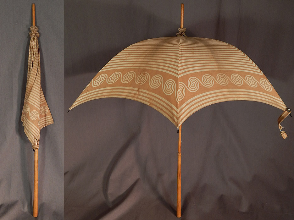 Victorian Brown Spiral Striped Cotton Wood Handle Summer Beach Parasol
This Victorian era antique brown spiral striped cotton wood handle summer beach parasol dates from 1900. It is made of an ecru cream color cotton fabric with a light brown spiral striped pattern print design. There is light blonde wood handle stick, finial top with gathered fabric ruffle trim. 