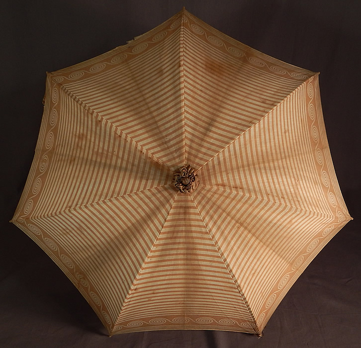 Victorian Brown Spiral Striped Cotton Wood Handle Summer Beach Parasol
This summertime beach parasol umbrella has a pagoda dome shape, with black metal frame inside, unlined and the original button strap for keeping closed. The parasol measures 31 inches long and 87 inches in circumference when opened. 