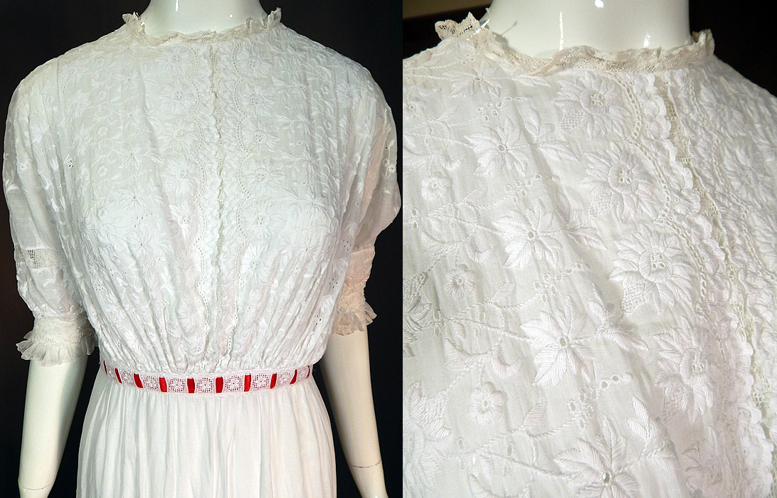 Edwardian White Cotton Batiste Floral Eyelet Embroidered Lace Lawn Dress Tea Gown
This exquisitely embroidered lawn dress is a long tea length, with a lace trim neckline, lace trimmed fitted cuffs short sleeves, a red ribbon accent woven through the waistband and skirt, tiny crochet button closures down the back and is lined only in the skirt with a cotton petticoat sewn inside. 