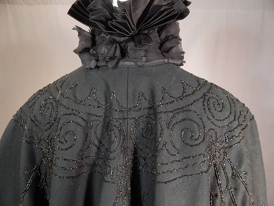 Victorian Black Wool Jet Beaded Pleated Silk High Neck Collar Winter Cloak Cape
It is in good condition, with only a few loose missing beads. This is truly a wonderful piece of antique Victoriana winter mourning wearable art!