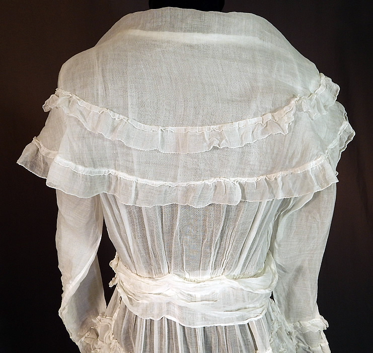 Edwardian White Cotton Organdy Ruffled Fichu Belted Dress Tea Gown
The dress measures 47 inches long, with a 36 inch bust, 25 inch waist, 44 inch hips, 22 inch long sleeves and a 12 inch back. It is in excellent condition. This is truly a wonderful piece of wearable art! 