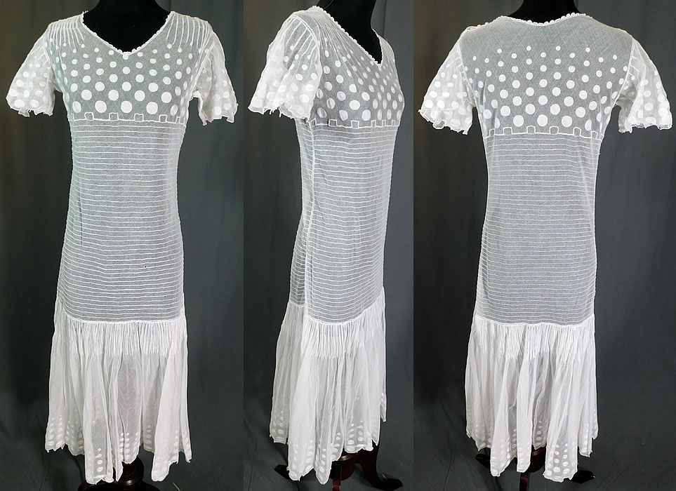 Vintage Polka Dot Embroidered White Tulle Net Pleated Shift Drop Waist Dress
This vintage polka dot embroidered white tulle net pleated shift drop waist dress dates from the 1920s. It is made of a white sheer tulle net fabric, with pleating and polka dot embroidery work designs along the top and bottom skirt.