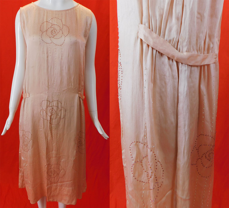 Vintage Art Deco Pink Pastel Silk Beaded Flowers Drop Waist Flapper Dress
This pretty in pink flapper dress has a loose fitting shift A-line drop waist style, with belted side straps gathering on the hips, sleeveless and is unlined.