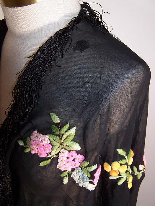 Vintage Black Silk Chiffon Pastel Yarn Embroidered Floral Fringe Shawl Cape only a small old woven mend on the shoulder close up.