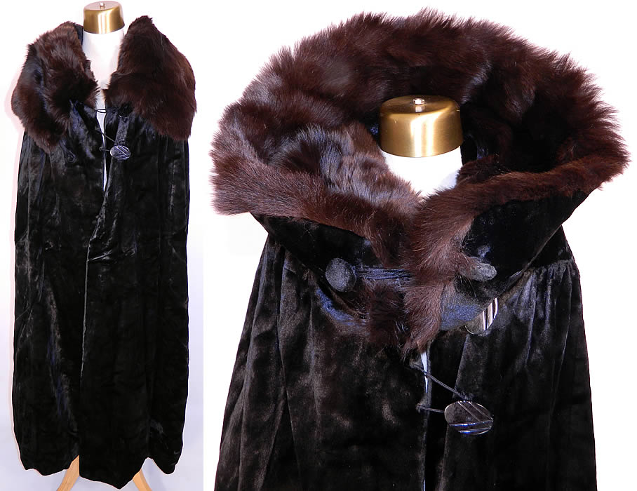 Vintage Salt's Peco Black Plush Silk Seal Velvet Opera Cloak Winter Cape. It is made of a black silk seal faux plush velvet fabric, with a large brown fur trim collar. This wonderful winter cape cloak is floor length, with a large shawl collar which can be worn in a stand-up style as a hood, or folded down, with black button closures. 