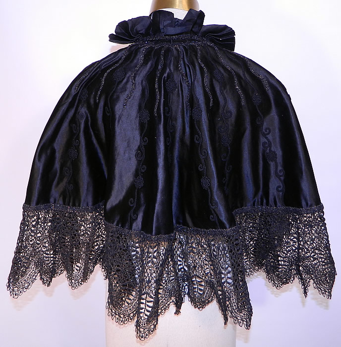 Victorian Black Silk Jet Beaded Lace Trim Evening Cloak Cape. The cape measures 22 inches long, with a 88 inch bottom circumference and 15 inch neck.