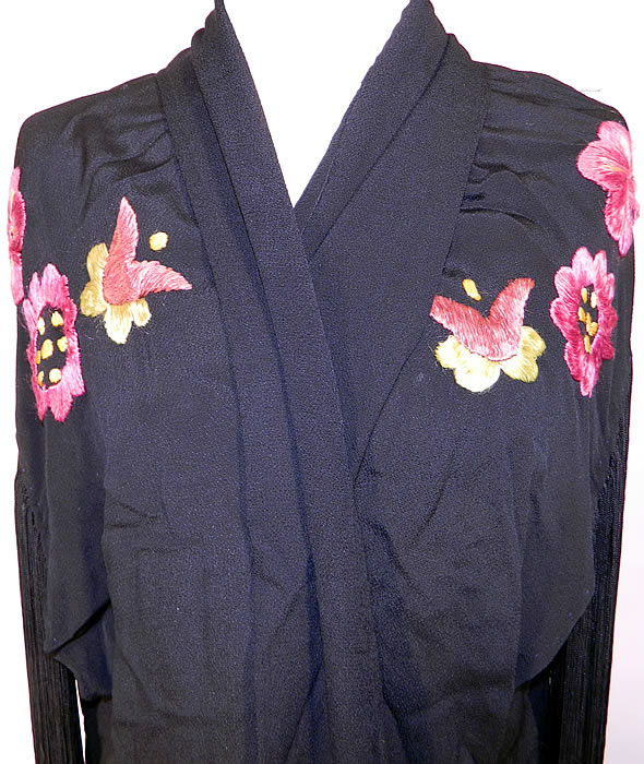 Vintage Art Deco Black Silk Floral Embroidered Piano Shawl Long Robe Coat. It is made of black silk crepe fabric, with pink and yellow silk raised padded satin stitch embroidered flowers and Art Deco abstract fan, feather leaf designs.