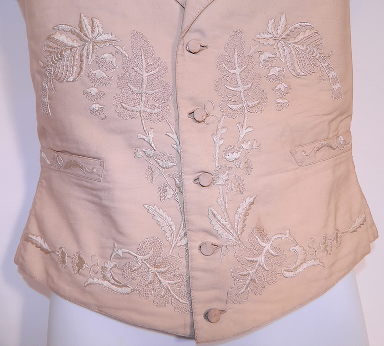 Victorian Gentleman's Cream Wool Embroidered Wedding Waistcoat Vest. There is a white polished cotton fabric backing, with a flared skirted bottom back, an adjustable brass buckle strap on the back and is fully lined inside. 