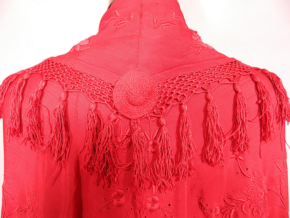 Antique Edwardian Red Silk Embroidered Tassel Piano Shawl Cloak Cape. There are embroidered floral vine leaf designs. This radiant red cloak cape was custom made and created from an antique Spanish Flamenco style piano shawl, with hand knotted macramé red silk fringe trim edging and a back shawl collar. 