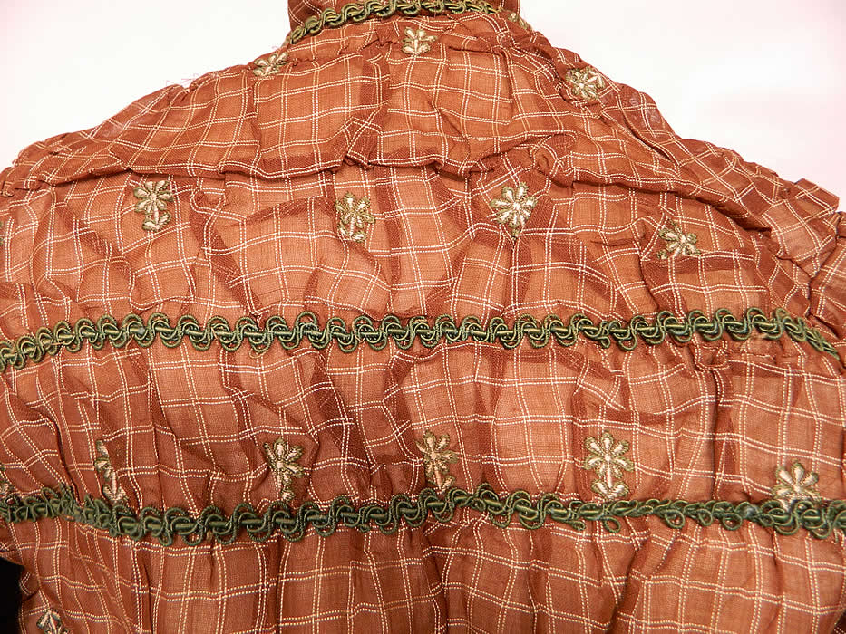 Victorian Civil War Brown & White Plaid Muslin  Green Floral Trim Embroidered Dress. It is in good condition, with only a few small frays on the skirt. 