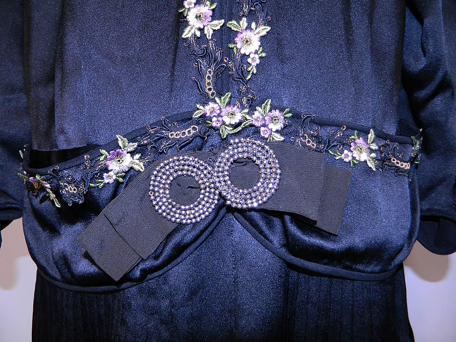 Vintage Flapper Black Silk Gold Violet Floral Embroidered Trim Drop Waist Dress. This fabulous flapper dress is loose fitting, with a drop waist, long sleeves, with scalloped gathered cuffs, a layered open front skirt and belted sash with steel cut buckle trim accent.