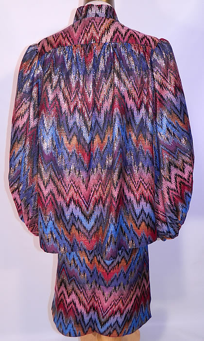 Vintage Mr. Blackwell Custom Missoni Style Striped Zigzag Lamé Suit Jacket & Skirt. The jacket measures 26 inches long, with 50 inch hips, a 50 inch waist, 44 inch bust, 14 inch back and 25 inch long sleeves. There is a matching fabric skirt, with side slit, an elastic waistband and is fully lined. The skirt measures 26 inches long, with 36 inch hips and a 26 to 30 inch waist.