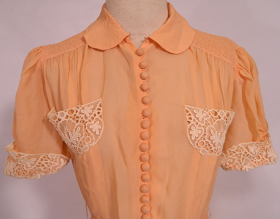 Vintage Peach Pastel Silk Chiffon White Lace Trim Belted Summer Day Dress. It is sheer and unlined. The dress measures 41 inches long, with 36 inch hips, a 26 inch waist and 36 inch bust. It is in good condition. This is a wonderful piece of wearable art! 