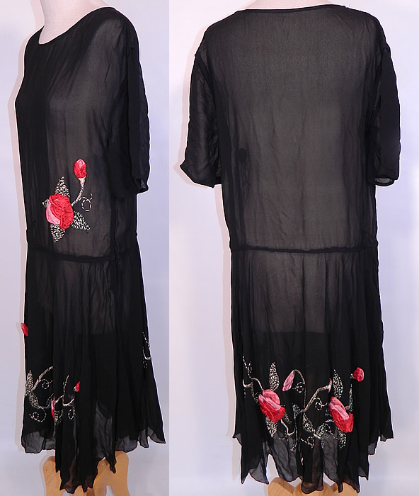 Vintage Black Silk Chiffon Red Roses Ribbon Rosette Trim Drop Waist Dress.  It is in good condition, with only some slight fraying on the silk rosette flower trim. This is truly a wonderful piece of wearable Art Deco textile art! 