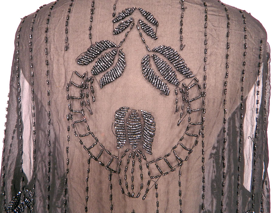 Vintage Art Deco Black Sheer Silk Chiffon Beaded Tulip Flower Flapper Dress. The dress is a large size measuring 46 inches long, with 48 inch hips, a 46 inch waist and 40 inch bust. It is in good condition. This is a wonderful piece of Art Deco wearable beaded textile art! 