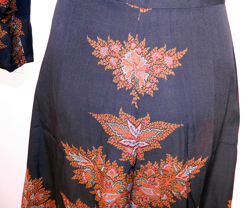 Vintage Red Orange Paisley Shawl Black Wool Dress. The dress measures 48 inches long, with 38 inch hips, a 28 inch waist, 38 inch bust, 14 inch back and 19 inch long sleeves. It is in good condition. This is truly a wonderful one of a kind wearable piece of paisley textile art!