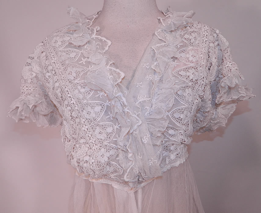 Edwardian Embroidered White Net  Lace Graduation Wedding Dress. This lovely lace long dress has a layered wrap top with ruffle trim edging, a fitted waist, short sleeves, a sheer skirt with front gathering and hook closures on the front. 