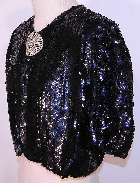 Vintage Black Sequin Beaded Rhinestone Clasp Cropped Bolero Evening Jacket. It is in good condition, with several missing rhinestones on the clasp closure and a few loose sequins