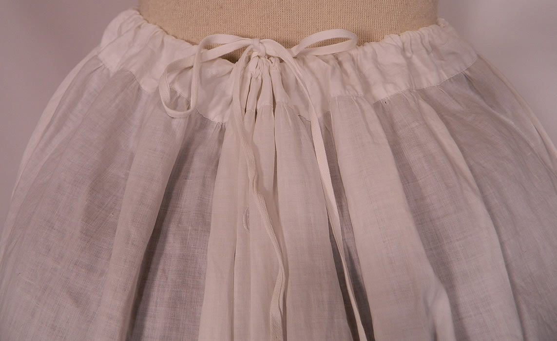 Victorian White Cotton Eyelet Lace Gathered Ruffle Bustle Back Petticoat Skirt. It is in good condition, with only a  tiny hole on the side. This is truly a rare and wonderful piece of antique Victoriana wearable art.