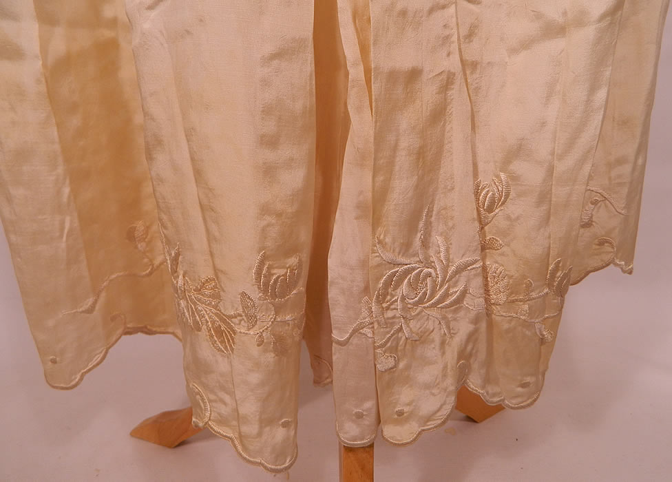 Edwardian Cream Silk  Embroidered Bed Jacket Robe Petticoat Skirt Trousseau. The jacket measures 21 inches long, with  a 46 inch waist and 46 inch bust. There is a long floor length petticoat skirt with bottom ruffle, scalloped hemline and hook closure on back. 