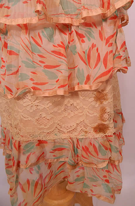 Vintage Silk Chiffon Tulip Print Lace Shawl Collar Ruffle Rosette Trim Drop Waist Dress. The dress measures 42 inches long, with 36 inch hips, a 32 inch waist and 36 inch bust. It is in good condition, with only some age spot stains on the bottom side skirt (see close-up). This is truly a pretty quality made piece of Art Deco wearable art! 