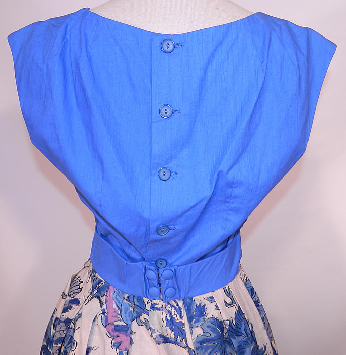 Vintage Tabak of California Sanganer India Hand Block Print Cotton Circle Skirt Dress. The top measures 16 inches long, with a 26 inch waist and 36 inch bust. Included is a full circle skirt, with pleating around the waist, a matching blue fabric on the open front, bottom hem trim and a back button closure. 