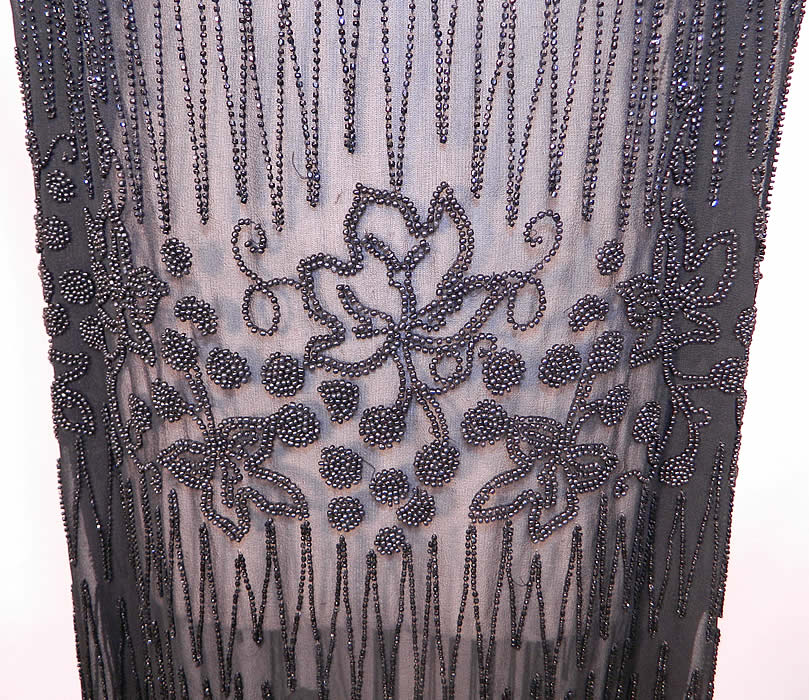 Vintage Art Deco Black Sheer Silk Chiffon Beaded Grape Leaf Flapper Dress. This fabulous flapper dress has a loose fitting straight shift style, sleeveless, with a beaded looped fringe trim skirt and is sheer, unlined. 