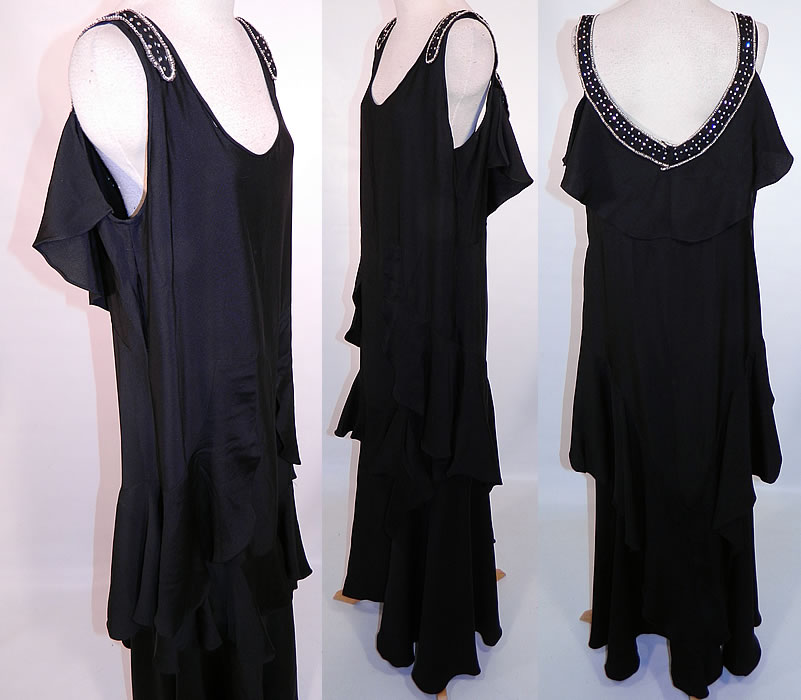 Vintage Art Deco Black Silk Crepe Ruffle Rhinestone Beaded Flapper Dress. This fabulous flapper dress evening gown is loose fitting, a long floor length with a ruffle tiered skirt, capelet flounce back, sleeveless, backless, unlined and side snap closures. 