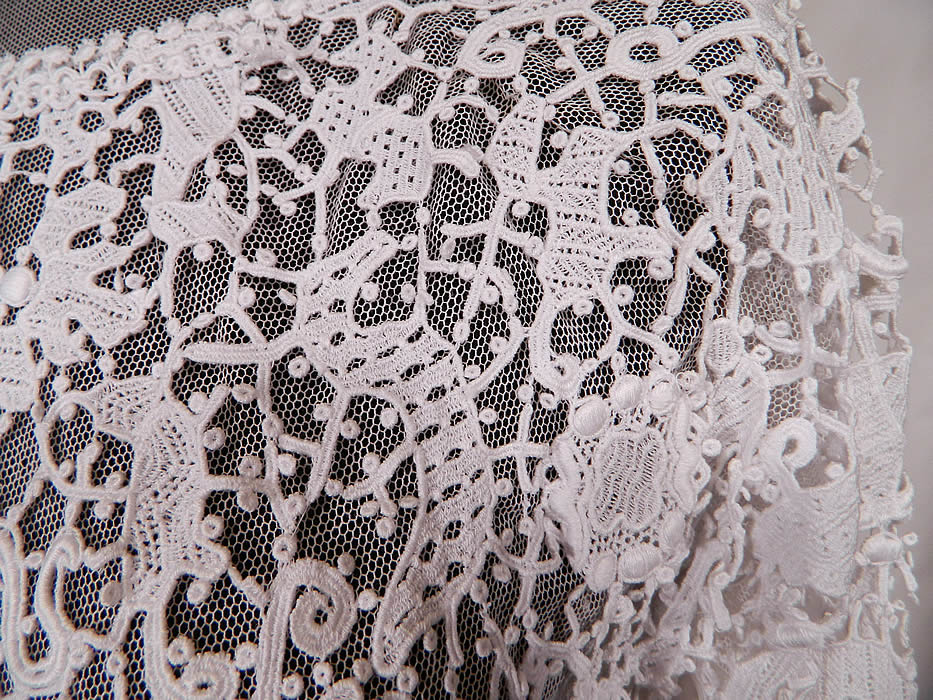 Edwardian White Needle Point Lace Figural Animal Insect Bird Blouse. 
This beautiful blouse has a sheer net neckline yoke with a scalloped trim high neck collar, long sleeves, a fitted waist, hook closures down the back and is fully lined in a white net mesh fabric with exposed bottom sides. 