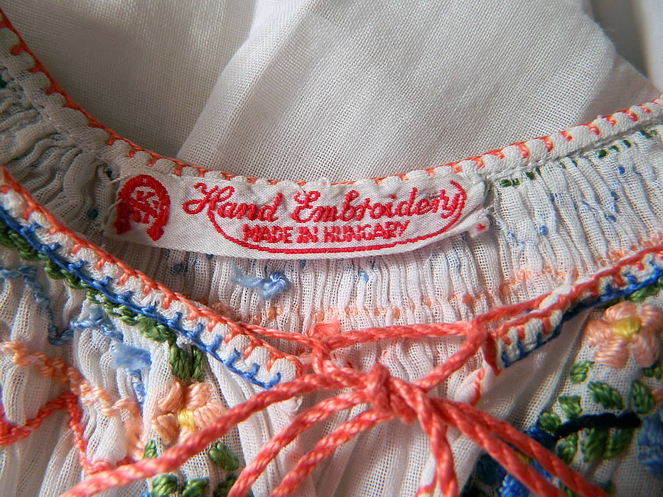 Vintage Childs White Cotton Colorful Embroidered Smocking Hungarian Peasant Dress
There is a "Hand Embroidery Made in Hungary" label sewn inside. 