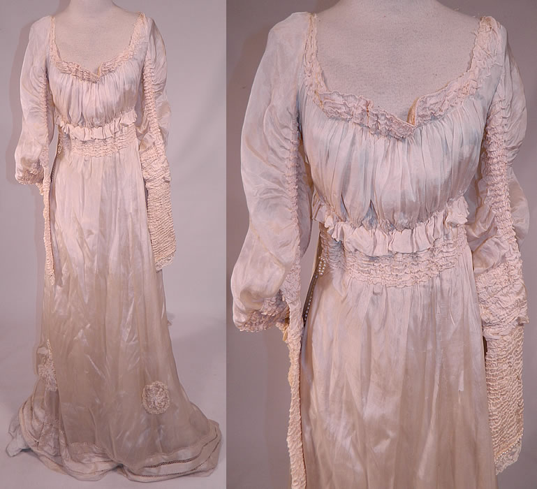 Edwardian Cream Silk Ruched Pearl Beaded Lace Trim Wedding Gown Train Skirt Dress
This antique Edwardian era cream silk ruched pearl beaded lace trim wedding gown train skirt dress dates from 1910. It is made of a cream silk fabric, with ruched tucks gathering on the sleeves, neckline, waist and drawn cut work, pearl beading, lace cobweb rosette appliqué trim accents on the skirt. 