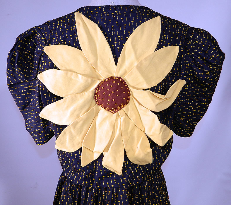 Vintage Navy Blue Yellow Sunflower Novelty Print Silk Sun Dress & Jacket
The jacket measures 15 inches long, with a 24 inch waist and 32 inch bust. It is in good condition, but does have some wear to the fabric on the front waist where the yellow floral pattern print has faded, rubbed off (see close-up). This is truly a wonderful piece of wearable art! 