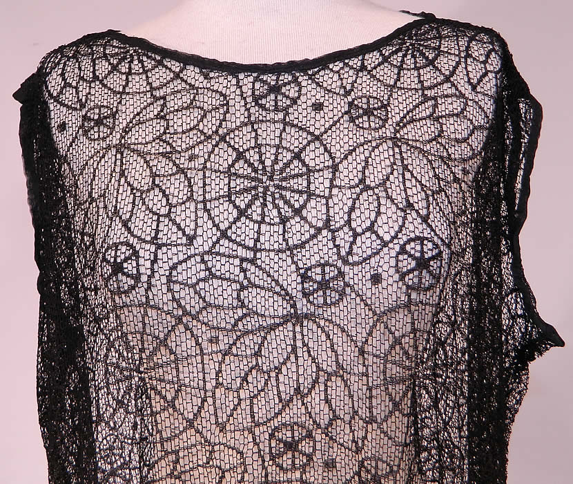 Vintage Black Spider Cob Web Lace Net Floral Pattern Drop Waist Flapper Dress
This fabulous flapper dress has a loose fitting drop waist sleeveless style, with scalloped bottom skirt and is sheer completely unlined.