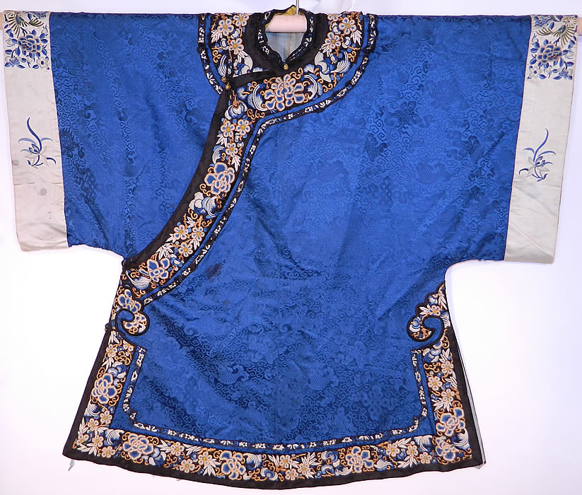 Antique Chinese Blue Silk Damask Brocade Forbidden Stitch Embroidered Trim Robe
There is a black silk trim collar and edging with beautifully hand embroidered, forbidden stitch Peking knot peony flowers and gold couching work accents. 