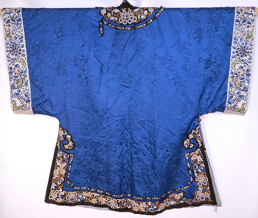 Antique Chinese Blue Silk Damask Brocade Forbidden Stitch Embroidered Trim Robe
There are blue silk embroidered sleeve cuff bands with green birds and butterflies. This magnificent Manchu womens robe has carved round brass buttons, silk loop toggles for closure along the side, long full sleeves with wide cuffs, side skirt vents and is fully lined inside.