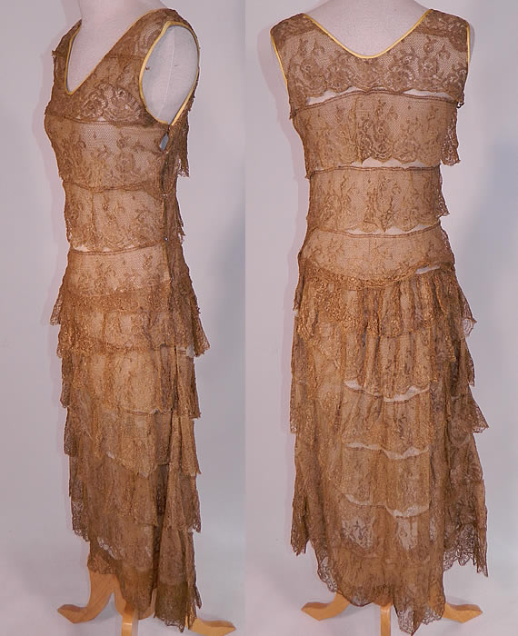 Vintage Gold Metallic Lamé Lame Lace Layered Tiered Ruffle Tango Flapper Dress 
This fabulous flapper, tango dance style fitted dress is sleeveless, with V necklines trimmed with gold silk trim edging, side snap closures and is lined in an off white cotton mesh net fabric with layers of gold lace trim ruffles tiered down. 