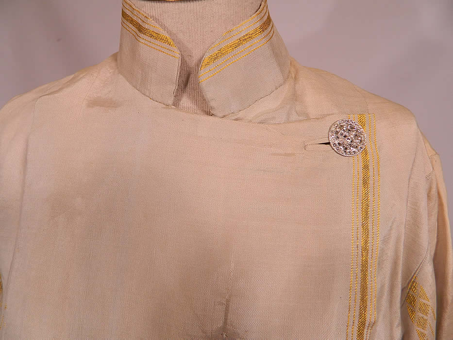 Vintage L.M. Rosen Gowns NY Label Art Deco Gold Lame Blue Silk Evening Coat Lamé
This elegant evening coat is loose fitting with a long length, full boxy style, mandarin collar, long full sleeves, bottom side slits, silver filigree rhinestone button closures along the side and is fully lined in a cream silk satin fabric.