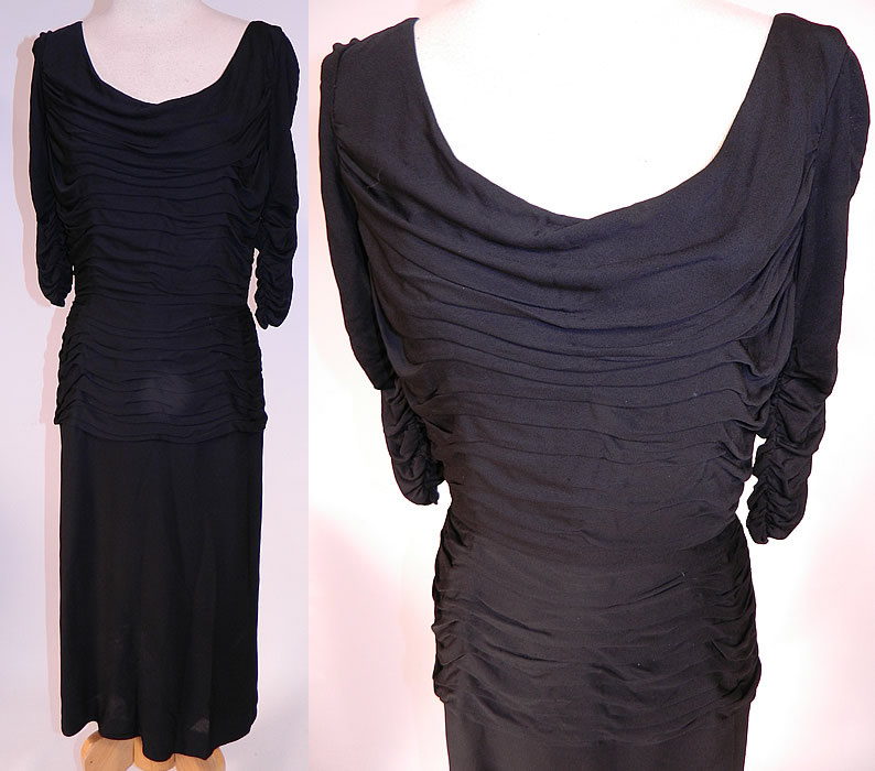 Vintage Black Silk Jersey Pleated Gathering Sexy Sheath Cocktail Dress
This vintage black silk jersey pleated gathering sexy sheath cocktail dress dates from the 1960s. It is made of a black silk jersey knit fabric, with pleated gathering layered details on the top. This sexy wiggle cocktail party dress has a form fitting sheath style, with a draping low rounded scoop front neckline, plunging V back, gathering along the 3/4 length sleeves, more pleated gathering along the peplum hips, a mid length pencil skirt, fully lined and has a back zipper closure.