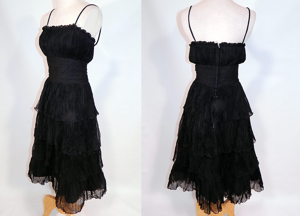 Vintage Suzy Perette NY Label Black Silk Pleated Ruffle Spaghetti Strap Cocktail Dress
This beautiful black cocktail dress has a form fitting sheath style, pleated shelf top with spaghetti straps, a wide cummerbund waist, tiered layered ruffle skirt, back zipper closure and is fully lined. 