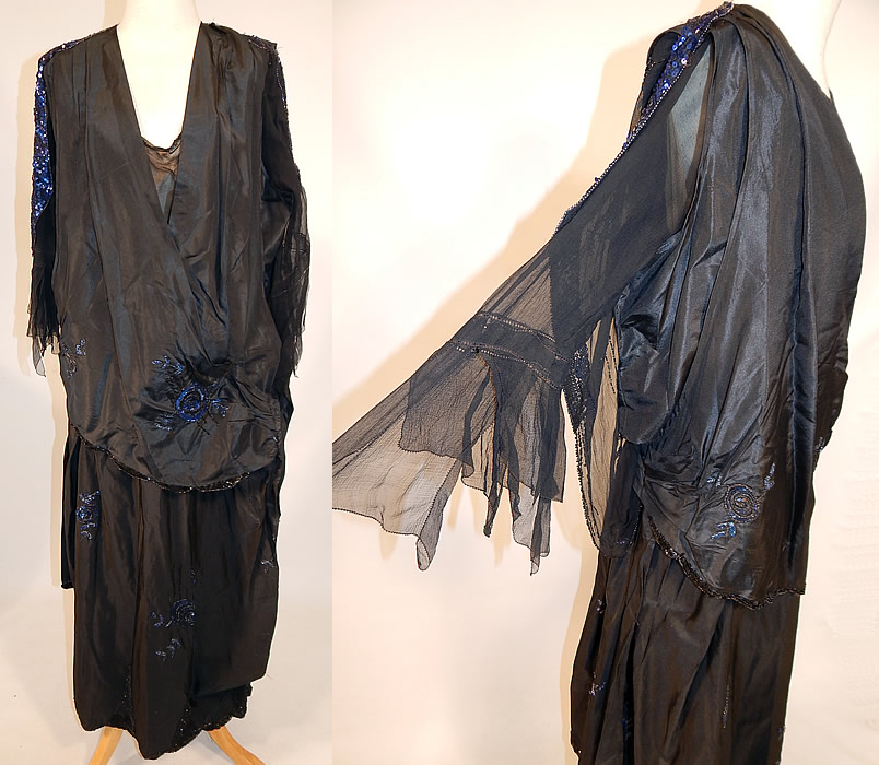 Vintage Art Deco Black Silk Taffeta Blue Sequin Beaded Flapper Dress Evening Gown
This amazing Art Deco vintage black silk taffeta blue sequin beaded flapper dress evening gown dates from the 1920s. It is made of a black silk taffeta fabric, with black and blue sequin beading done in striped, floral rose leaf pattern designs.