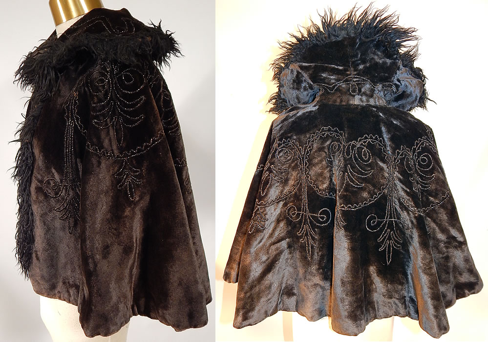 Victorian Black Velvet Jet Beaded Mohair Trim Winter Cloak Cape Mantle
 This antique Victorian era black velvet jet beaded mohair trim winter cloak cape mantle dates from 1880. It is made of a black heavy plush velvet fabric, with jet beading done in decorative designs and black mohair Angora goat curly fur trim edging around the collar and down the front opening.