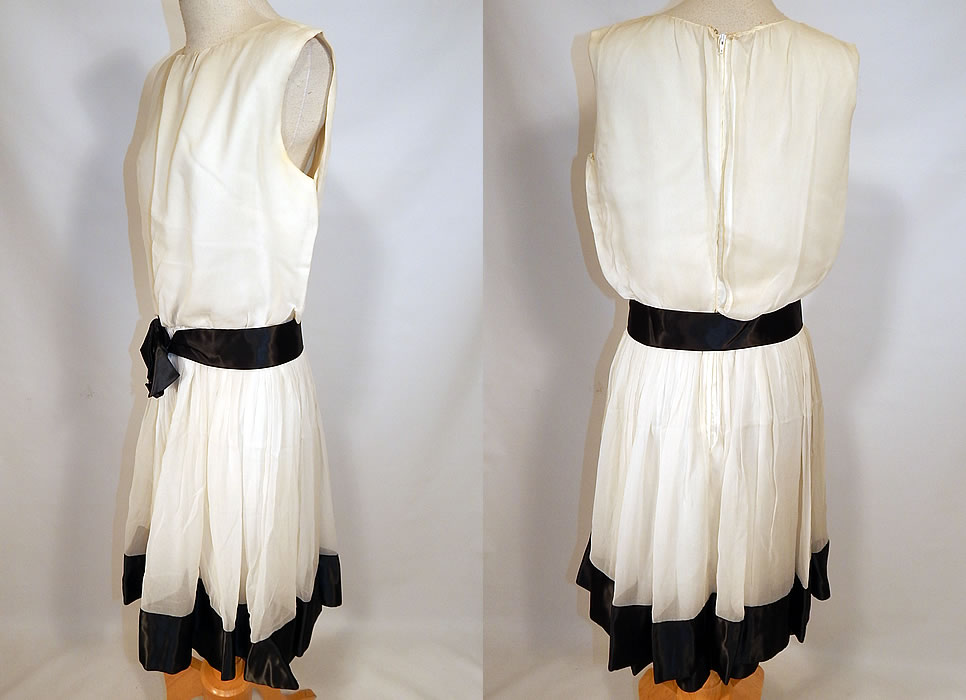 Vintage Mod Black & White Chiffon Belted A Line Sleeveless Cocktail Dress
This marvelous mod cocktail dress has an A line style, sleeveless, a pleated flared full skirt, fitted waist with attached belt, back zipper closure and is fully lined.