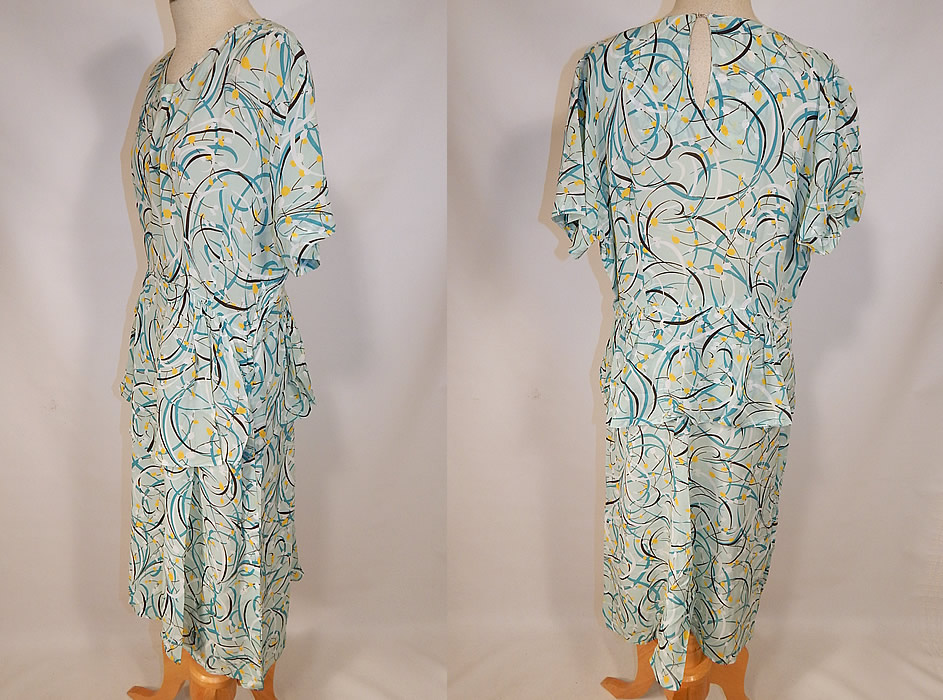 Vintage Teal Blue Floral Swirls Abstract Novelty Print Rayon Peplum Skirt Dress
This beautiful blue novelty print dress has a peplum skirted waist layered skirt, short sleeves, a key hole opening back and side zipper closure. 