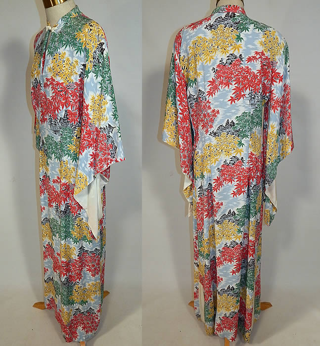 Vintage Liberty House Hawaiian Maple Leaf Print Rayon Pake Muu Muu Dress
This retro Hawaiian pake muu muu style long floor length loose fitting dress has slight shoulder padding, wide flared bat wing kimono sleeves lined in cream, a mandarin collar with toggle closure at the neck, key hole front opening, side slits on the skirt and side zipper closure. 