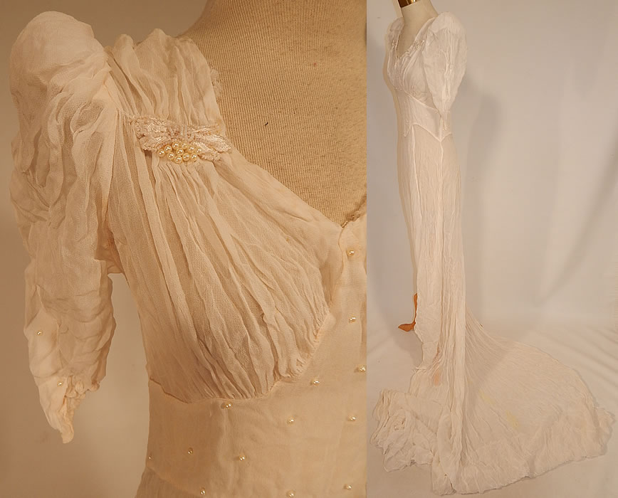 Vintage White Silk Crepe de Chine Pearl Beaded Wedding Gown Dress Long Train Skirt
 This beautiful bridal wedding gown dress has a sweetheart neckline, slightly padded shoulders, short puffy sleeves, a fitted waist, very long back train skirt with loop for carrying, silk covered button back closures and is sheer, unlined.