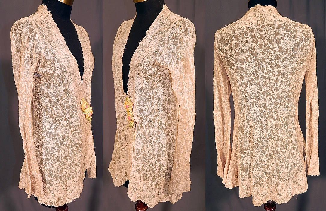 Vintage Silk Ribbon Rosette Trim Cream Tambour Embroidery Net Lace Jacket
This lovely lace boudoir jacket is a long mid length, with a form fitting wrap style, long tapered sleeves, a scalloped low V neckline, snap closure under the rosette trim and is sheer, unlined.