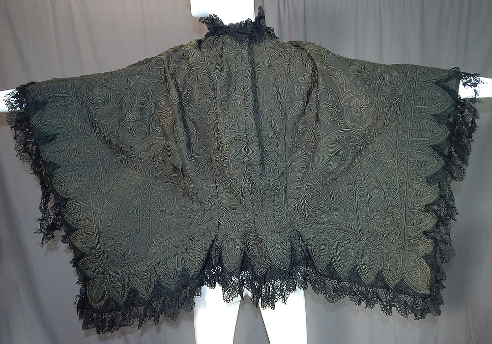 Victorian Black Wool Soutache Embroidery Work Lace Dolman Mantle Cape
This magnificent winter dolman mantle style cloak cape has a scalloped trim bottom edging, black lace trim ruffle neck collar, hook closure at the neck and is fully lined. 