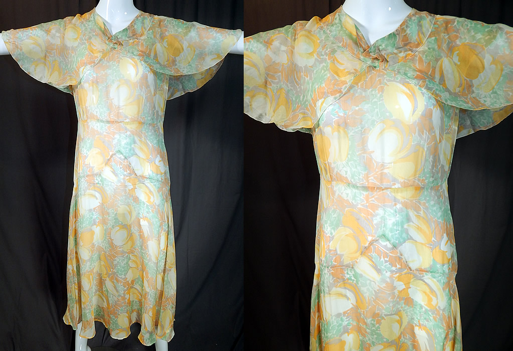 Vintage Yellow Tulip Flower Print Silk Shawl Collar Cape Bias Cut Dress
This vintage yellow tulip flower print silk shawl collar cape bias cut dress dates from the 1930s. It is made of muted pastel shades of yellow, green and gold with an abstract tulip flower print on a sheer silk rayon blend fabric.